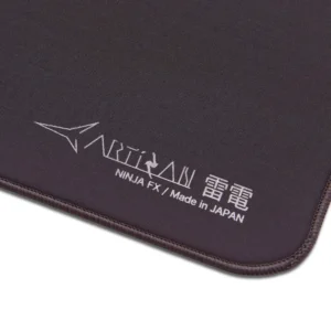 An image showcasing the corner of a coffee brown Artisan FX Raiden mouse pad